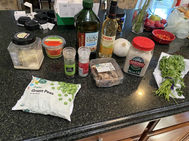 Ingredients gathered on the counter: oils, vinegar, mushrooms, peas, and fresh herbs