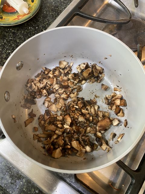 Chopped mushrooms cooking in a pan