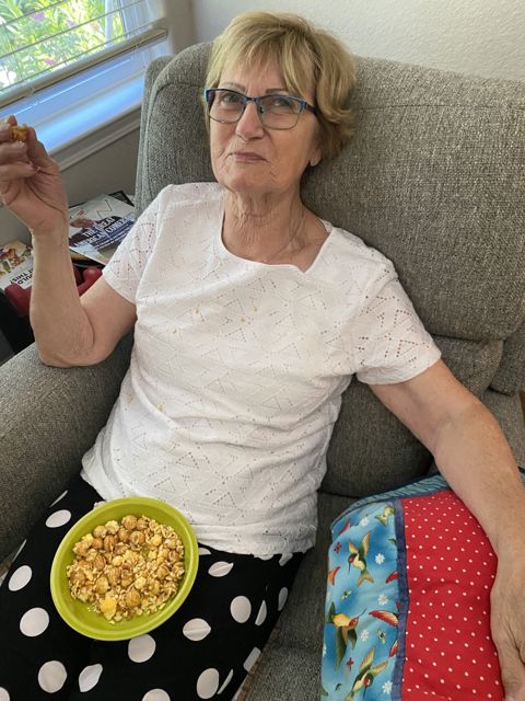 Relaxing on the sofa with a green bowl of snacks