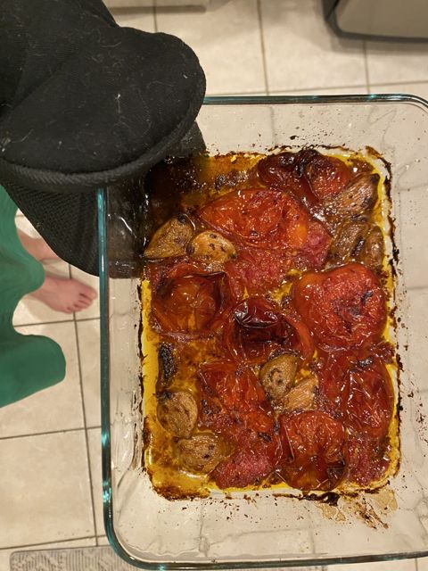 Tomatoes and garlic roasted deep red, fresh from the oven