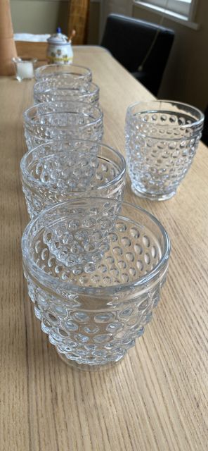 Bubble-textured glass tumblers on a wooden table