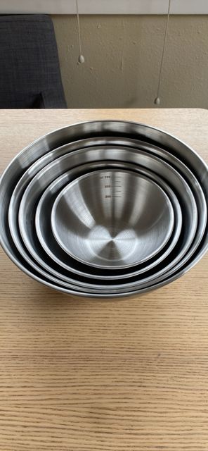 Nested stainless steel mixing bowls on a counter